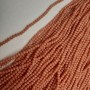 Beads Czech Crystal Peach Faceted Rondelle, diameter 3.5×3 mm, length 38 mm on beading thread