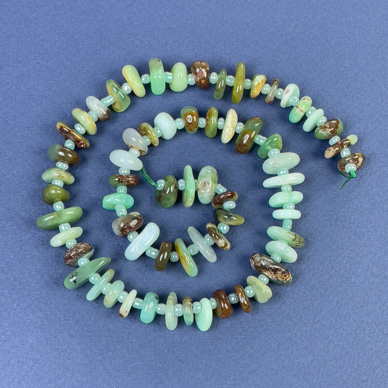 Chrysoprase faceted beads 10-14×3-5 mm ± with seed beads on a thread, length 40 cm+