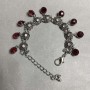 Bracelet with red crystals and pendants, length 18–23 cm, silver-tone metal