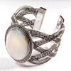 Wide mother-of-pearl bracelet in a metal bezel setting with Greek pattern, small oval
