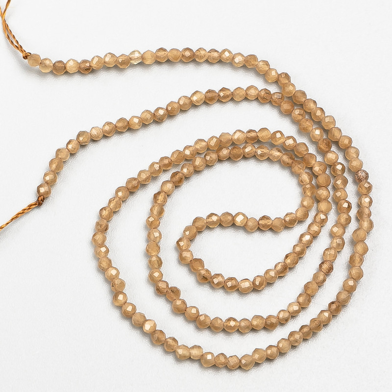 Small spinel beads (synthetic), light brown, faceted, 2 mm diameter, on a thread, 37 cm length